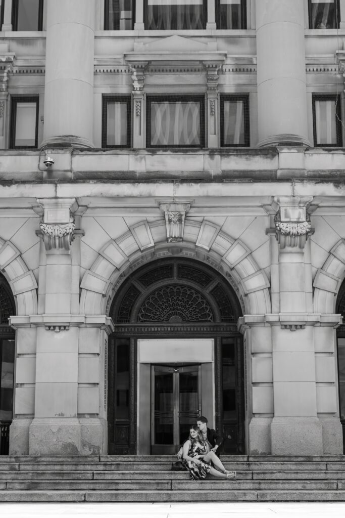 A chic downtown engagement session in black and white on the steps of the Omaha courthouse building.