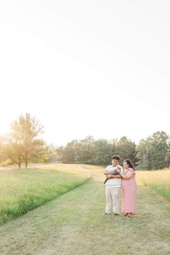A spring pregnancy photo session at Chalco Hills Recreation area with expecting parents and their pets.
