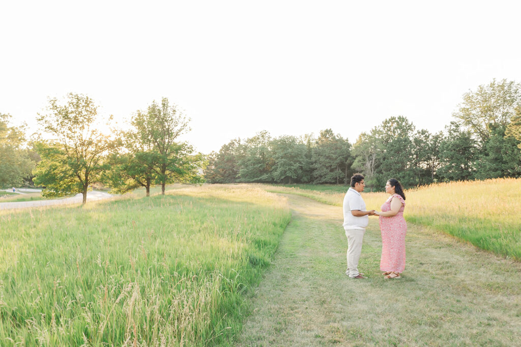 A spring pregnancy photo session at Chalco Hills Recreation area with expecting parents and their pets.