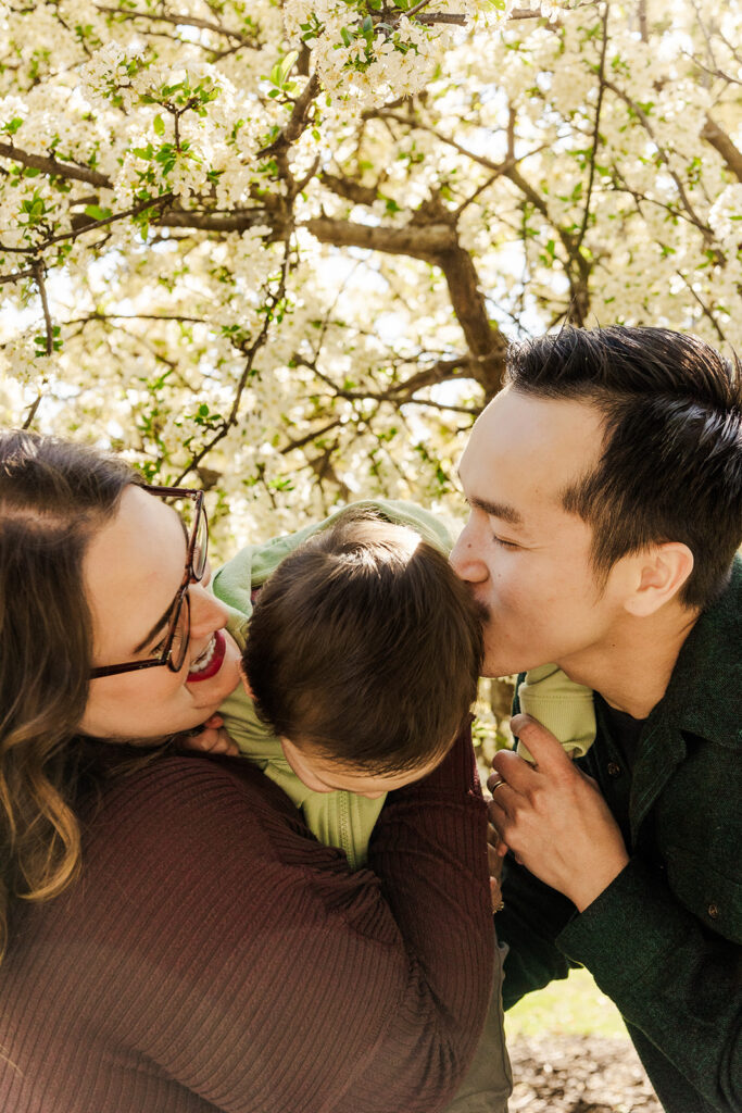 Beautiful spring flowers surrounding a family during a spring mini photo session at the Omaha OPPD Arboretum.