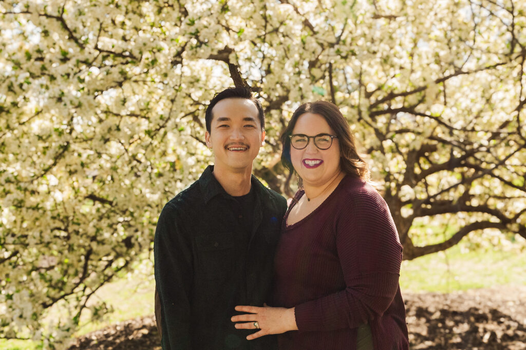Beautiful spring flowers surrounding a family during a spring mini photo session at the Omaha OPPD Arboretum.