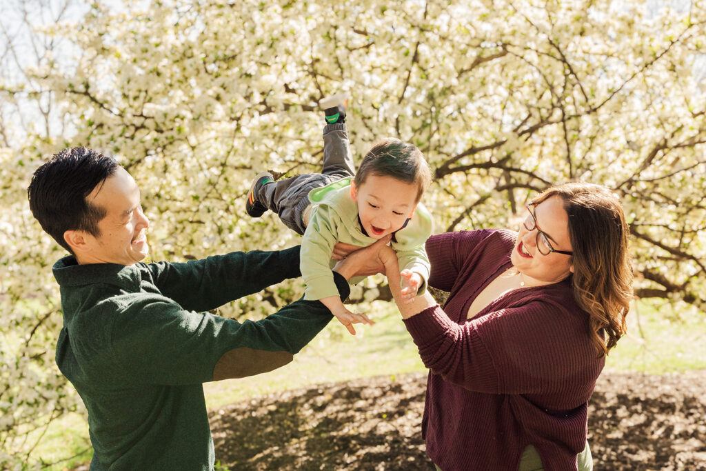 Beautiful spring flowers surrounding a family during a spring mini photo session at the Omaha OPPD Arboretum.