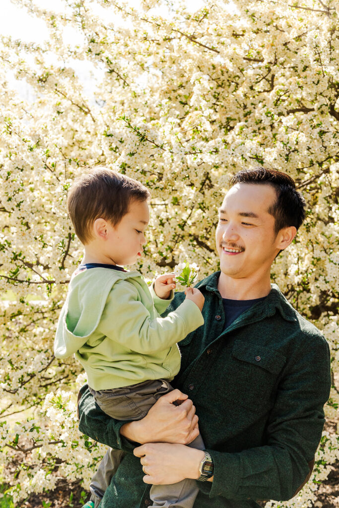 Beautiful spring flowers surrounding a family during a spring mini photo session at the Omaha OPPD Arboretum.