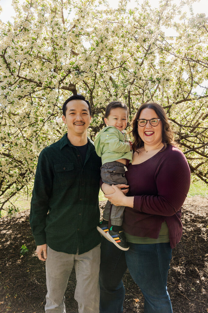 Beautiful spring flowers surrounding a family during a spring mini photo session at the Omaha OPPD Arboretum.