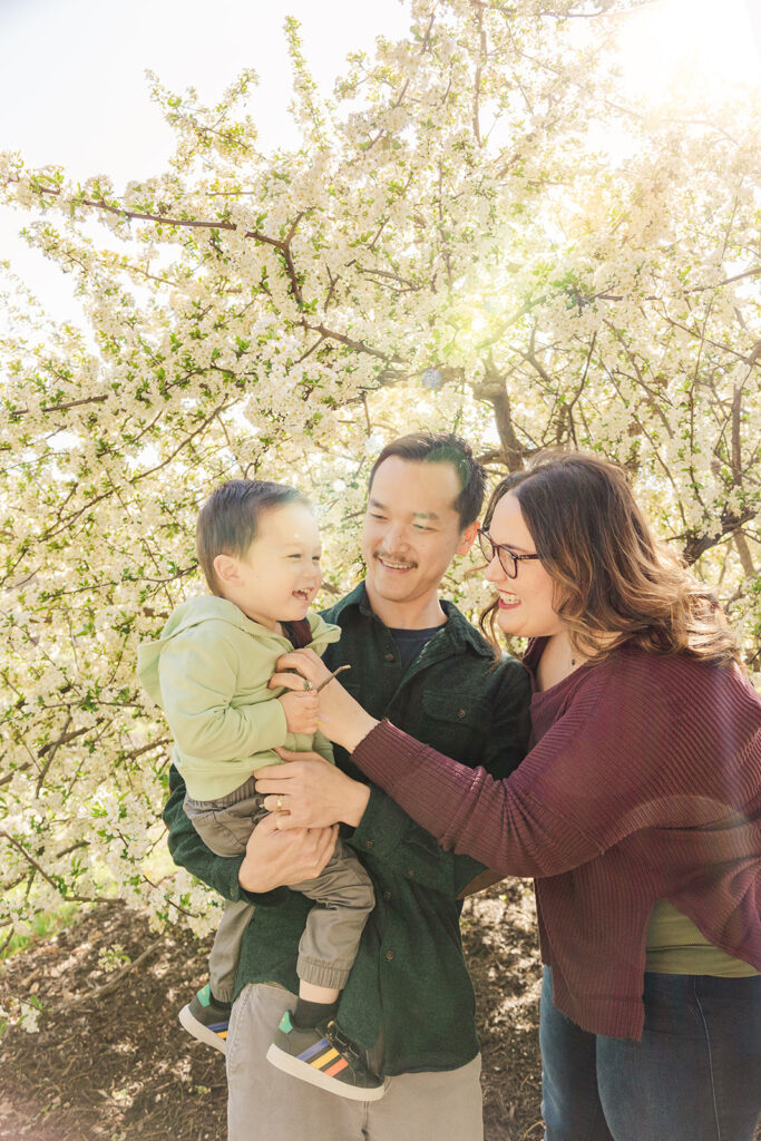 Beautiful spring flowers surrounding a family during a spring mini photo session at the Omaha OPPD Arboretum.