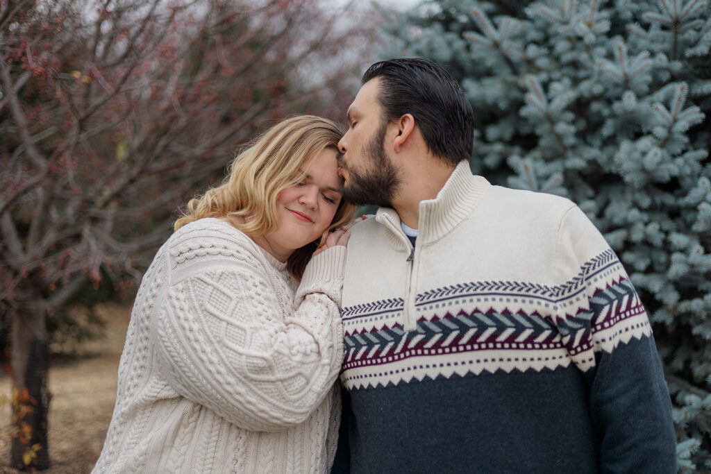 An OPPD Arboretum engagement photo session with evergreen trees.