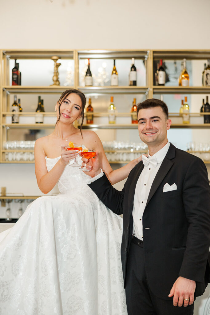 Couple clinking glasses at wedding reception at Empire Room in Omaha, NE.