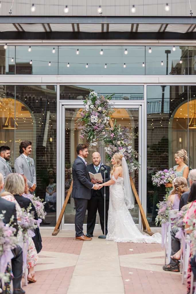 Couple says wedding vows at Magnolia Hotel in Omaha, NE.